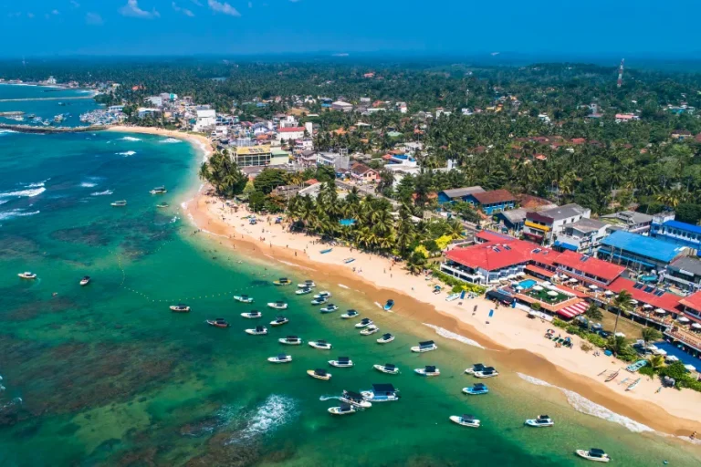 Stunning aerial view of Hikkaduwa Beach with turquoise waters and golden sands along Sri Lanka’s southern coast